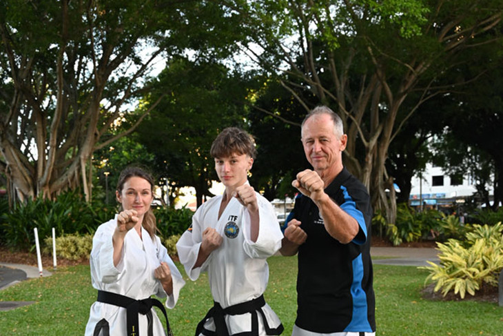 Mum Jasmyn Grundy, her son Hunter Thomson and master Jeff Dieben train in taekwondo on the Cairns Esplanade. Picture: Isabella Guzman Gonzalez