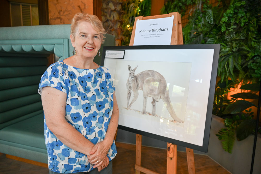 Award-winning Cairns artist Joanne Bingham with one of her animal portraits. Picture: Lizzie Vigar