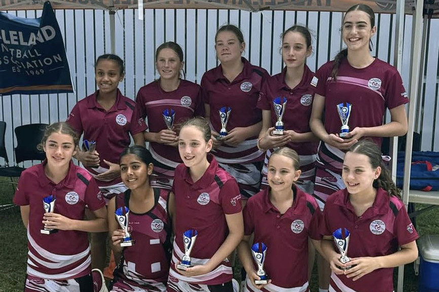 Innisfail’s under 13, 14 and 16 teams celebrate their victories with trophies in hand. Picture: Marlin Coast Netball