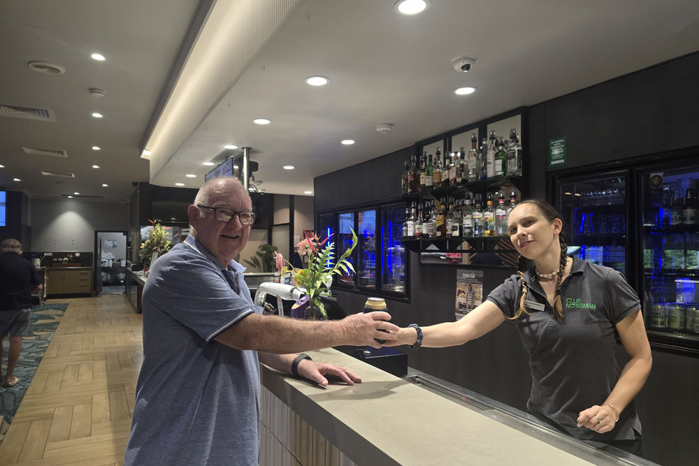 Club Mossman staff member Chanel serves patron Mike (surnames withheld) at the bar. Picture: Supplied