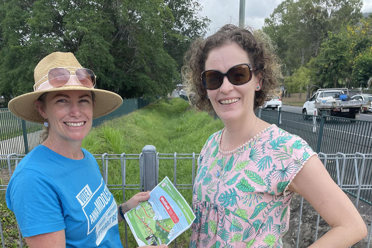 Division 7 candidiate Anna Middleton chats to resident Eve Elliott-Smith about the drain problems outside Whitfield State School. Picture: Supplied