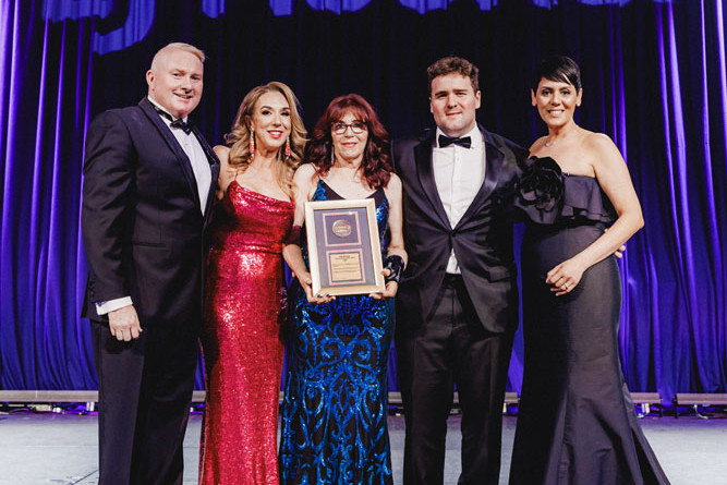 LJ Hooker Network Australia general manager Steve Mutton, Nadine Edwards, Despina Moller, Nick Moller and LJ Hooker Group CEO Christine Mikhael with the Hall of Fame award to the late Ross Moller.