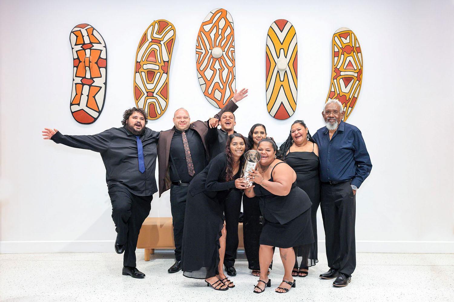 Mandingalbay Yidinji Aboriginal Corporation staff (from left) Mundi, Utah, Marshall, Tess, Brenda, Leann and Tamara (surnames not provided) with chairman Issac Mundraby celebrate their award. Picture: Front Row Foto
