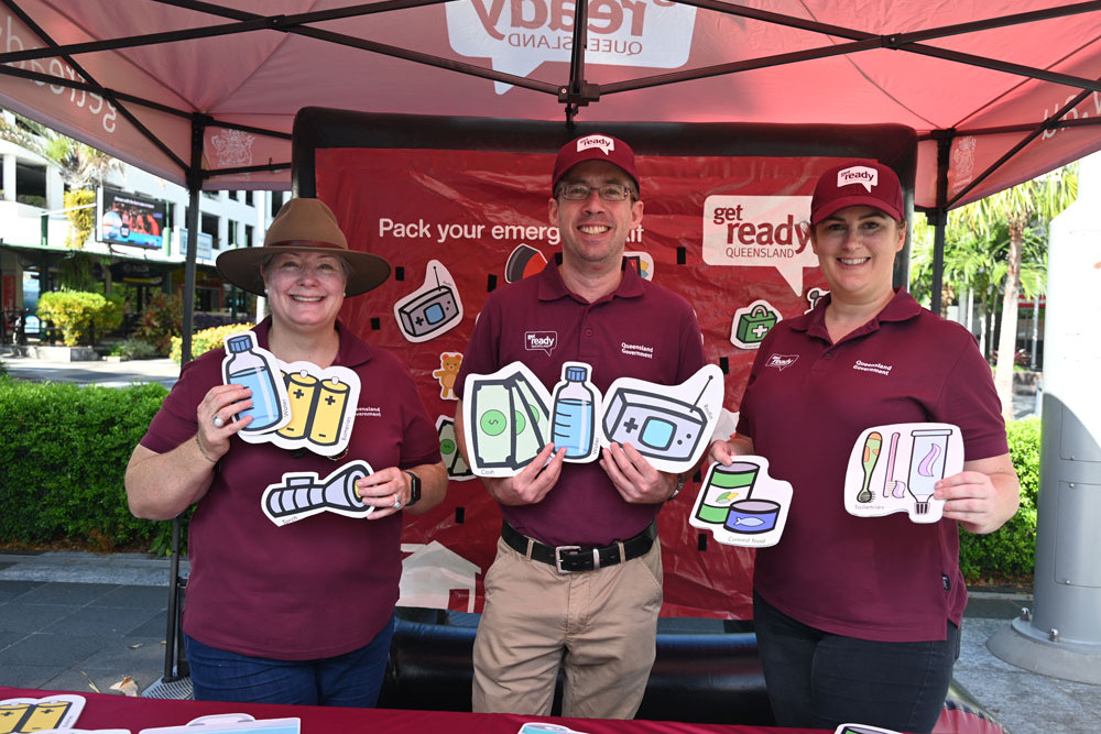 Get Ready Queensland team Louise Robertson, Jimmy Scott and Faye Gibson with some essential elements to put in your emergency kit. Picture:Isabella Guzman Gonzalez