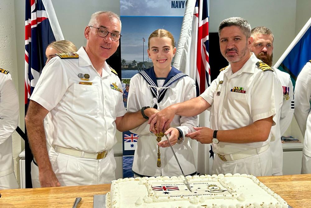 Cutting the HMAS Cairns 50th anniversary cake are Australian fleet commander Rear Admiral Christopher Smith, with seaman general experience sailor Sophie Evans and Commander Alfonso Santos. Picture: Defence