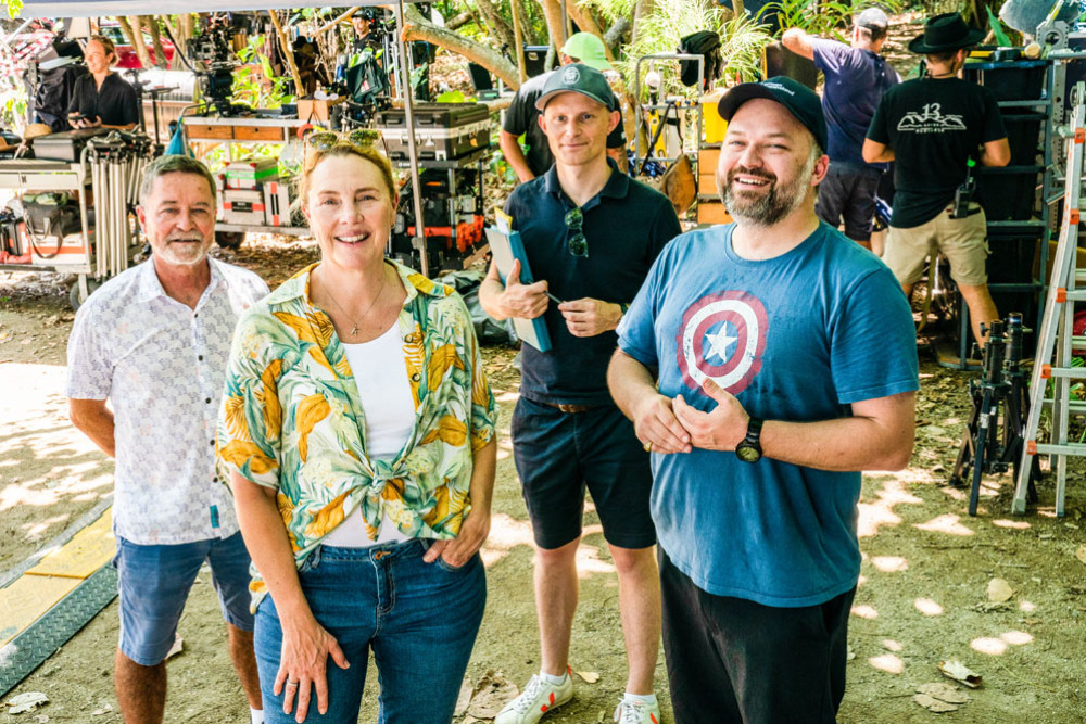 Irreverent producer Tom Hoffie, Screen Queensland chief executive Kylie Munnich, series showrunner, creator and writer Paddy Macrae and Screen Queensland head of studios Derek Hall on location during filming at Mission Beach. Picture: Supplied