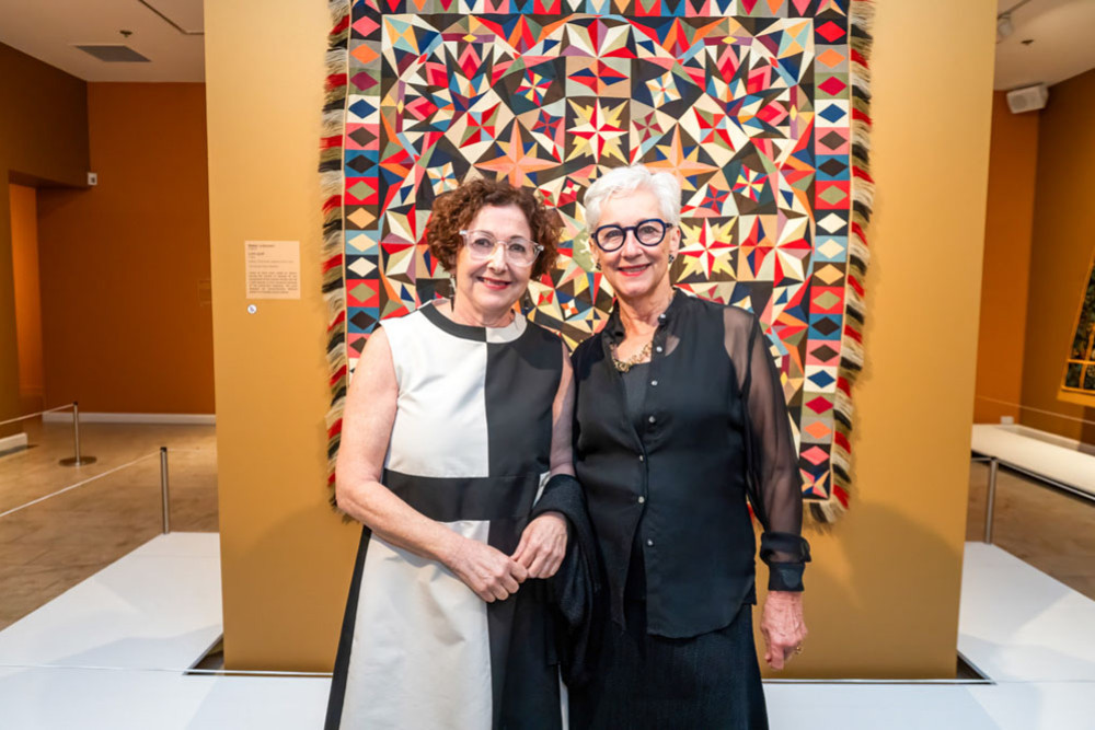 Cairns Art Gallery director Andrea May Churcher (left) with gallery senior curator Ingrid Hoffmann at the opening of War Quilts: The Annette Gero Collection. Picture: Cairns Art Gallery