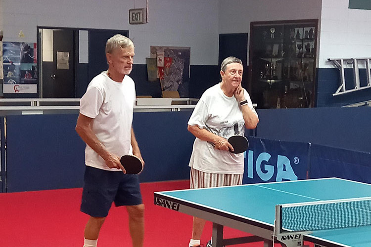 A group of senior citizens enjoy social table tennis twice a week.