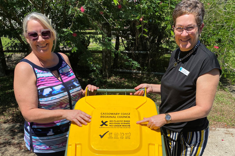 Councillor Ellen Jessop (left) and Mayor Teresa Millwood with a new yellow lid recycling bin. Picture: Cassowary Coast Regional Council