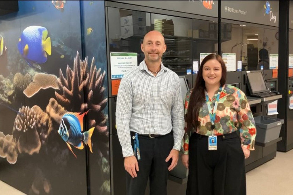 Pharmacy director Jason Black (left) and pharmacy project officer Jade Gileppa with the three robots. PIcture: CHHHS