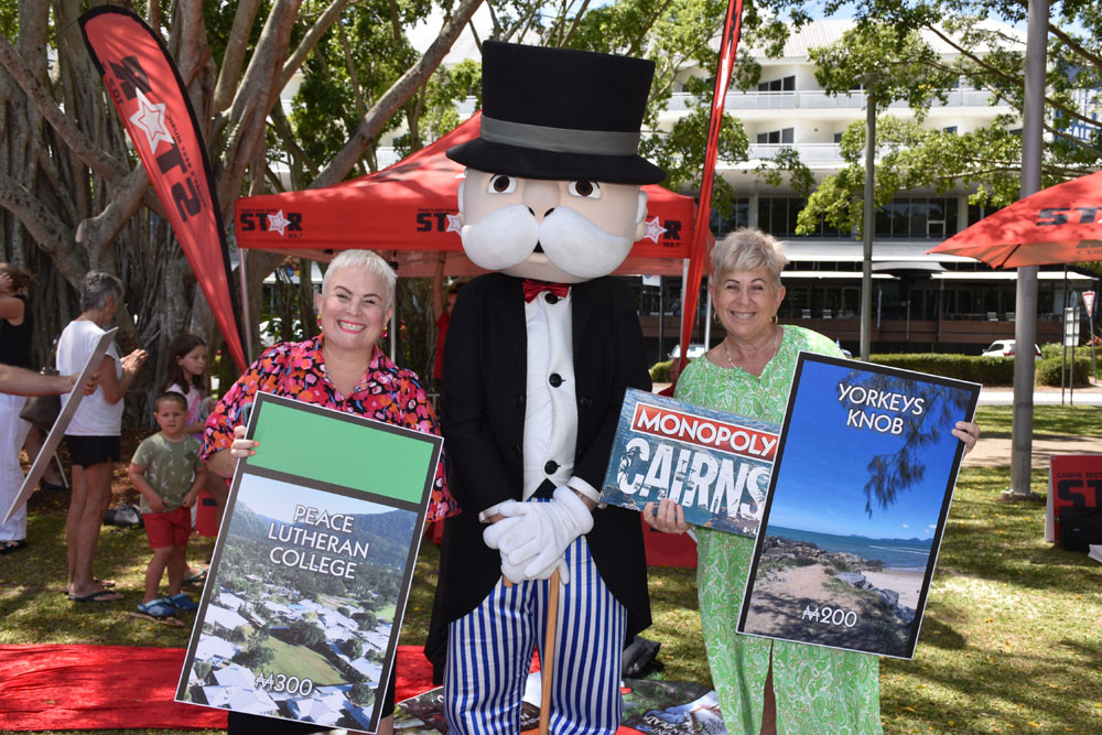 Cr Kristy Vallely holding the Peace Lutheran College square, Mr Monopoly and Cr Ronda Coghlan holding the Yorkeys Knob square. Picture: Isabella Guzman Gonzalez