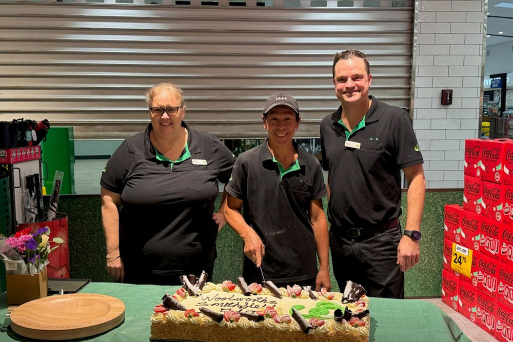 Woolworths assistant store manager Kerrin Crawford (left), Chris Soutter from the bakery team and store manager Paul Abbenbroek with the relaunch cake. Picture: Woolworths Group