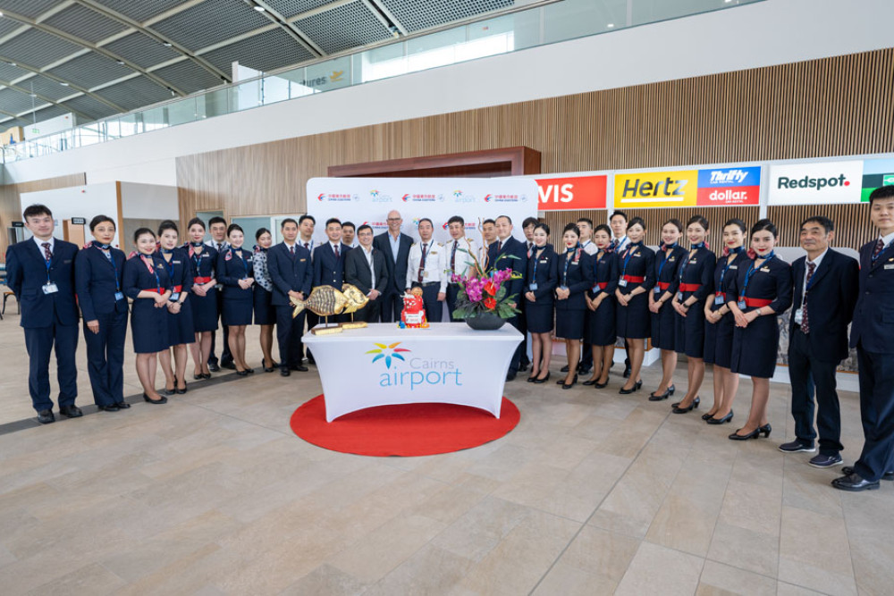 China Eastern Airlines’ crew and officials with Cairns Airport chief executive Richard Barker (centre).