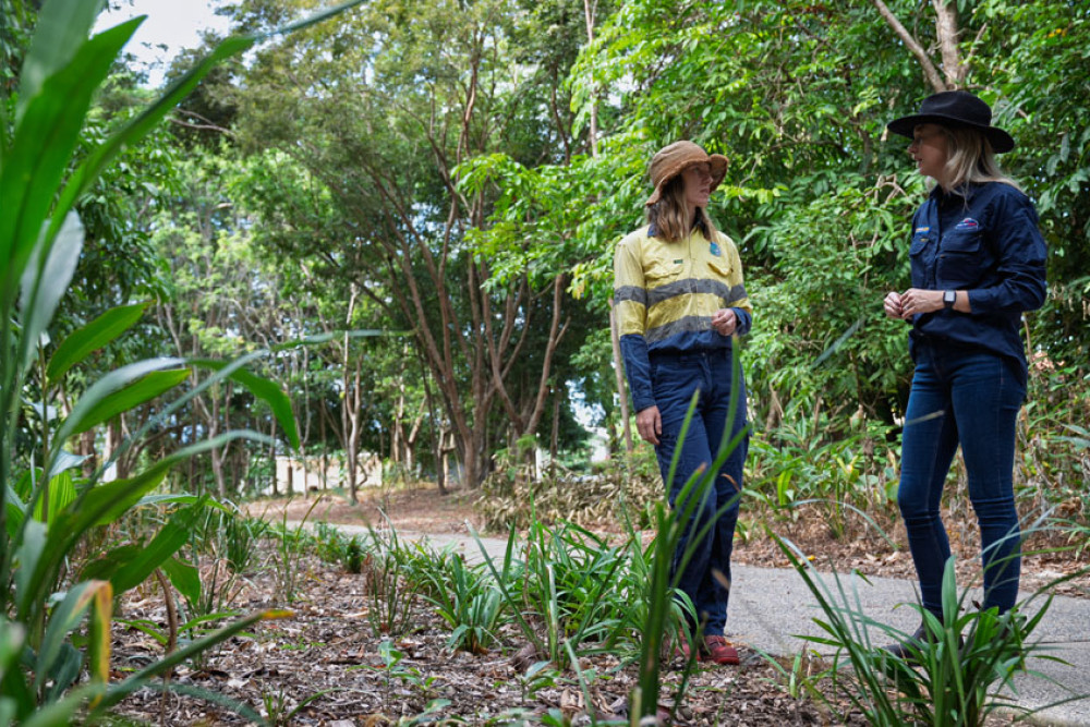 Sarah Sims from Cairns Conservation Services (left) discusses progress on the revegetation program around the Forest Gardens area with Rachael Maundrell from Powerlink. Picture: Powerlink