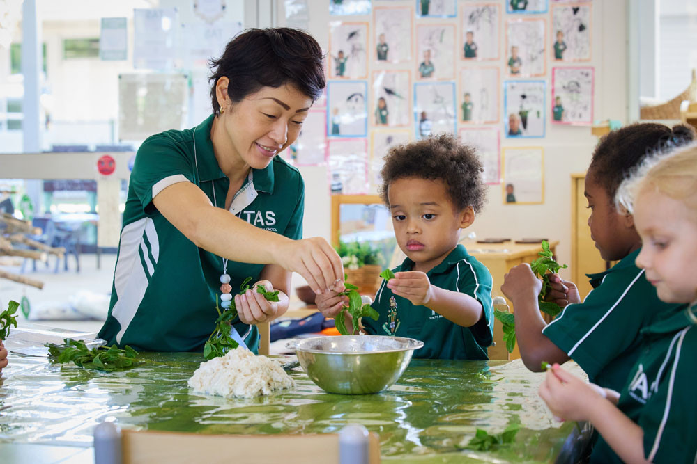 Trinity Anglican School’s early learning centre teacher Shihoko Eggett with kindy students. Picture: Romy Siegmann.