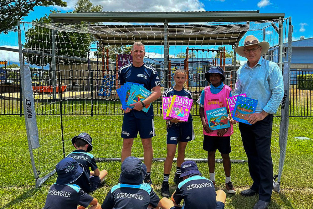 Andre Lohmann and Lloyd Perkins with students at Gordonvale Primary School