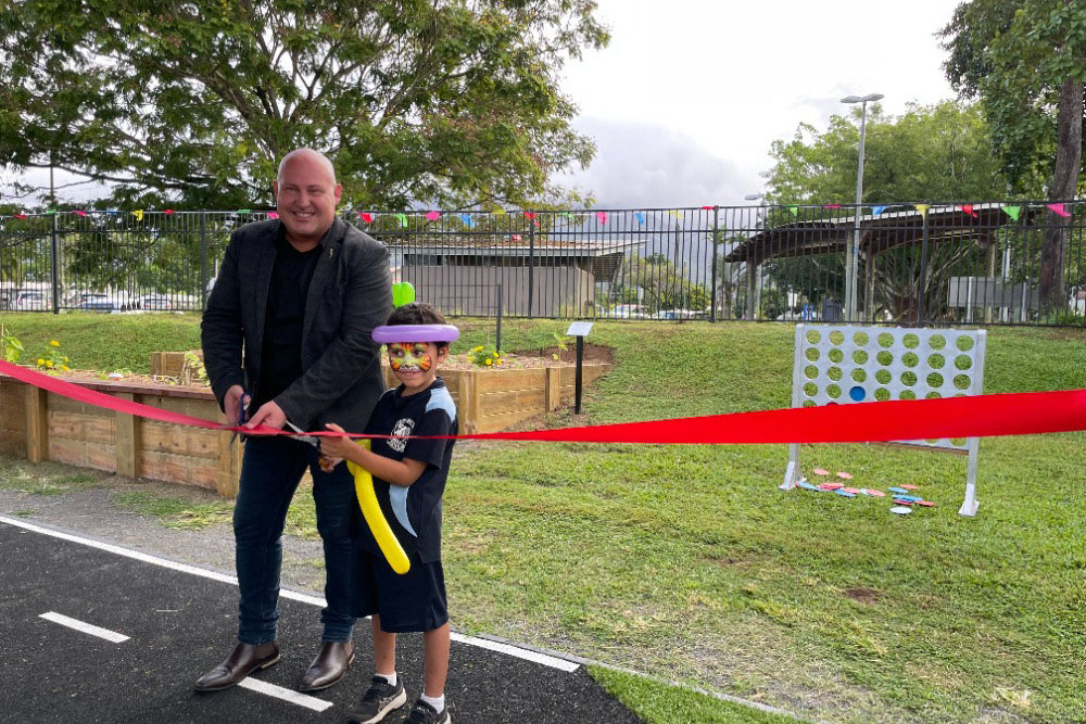 MP Curtis Pitt and Nakoa Fredriksson cut the ribbon and opened ‘Hambledon Highway’ at Hambledon House Community Centre. Picture: Mission Australia