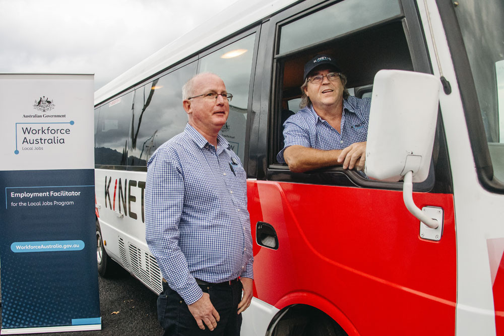 Kinetic north Queensland general manager John O’Brien (left) and driver Adam Rattray-wood with the bus which will take Yarrabah residents to Cairns and back. Picture: Kinetic
