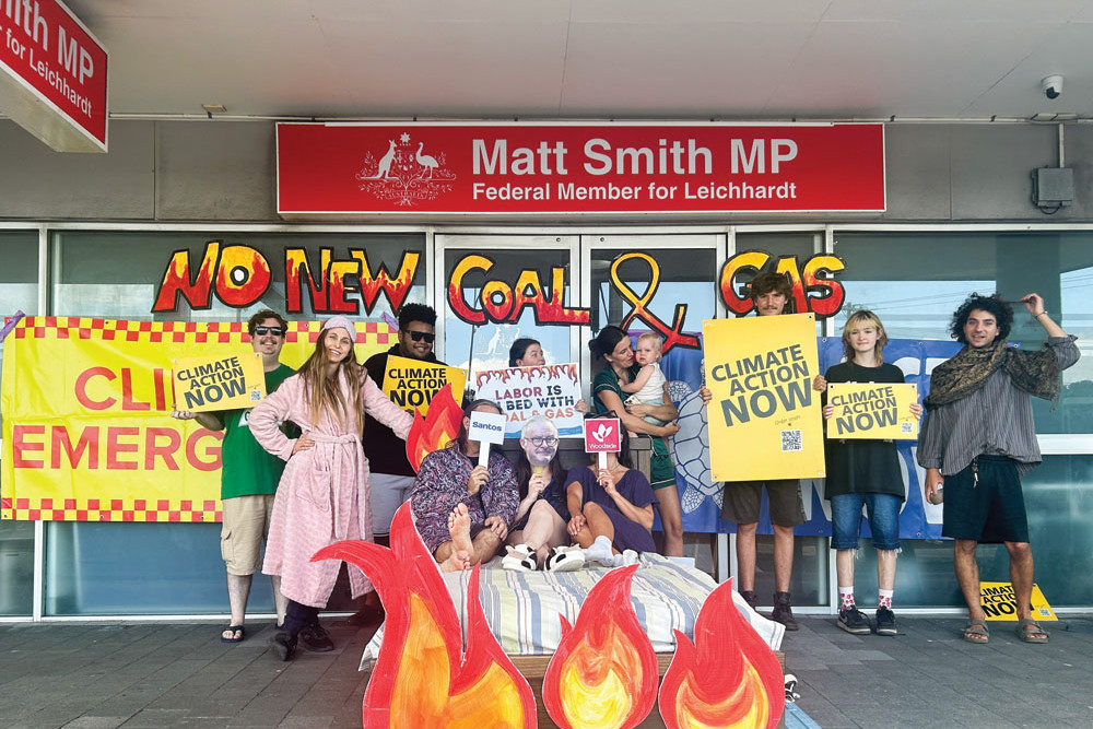 Protesters outside the Leichhardt electorate office staged a “sleep-in” with Cairns and Far North Environment Centre (CAFNEC) director Browyn Opie on the bed in the centre. Picture: Hugh Bohane
