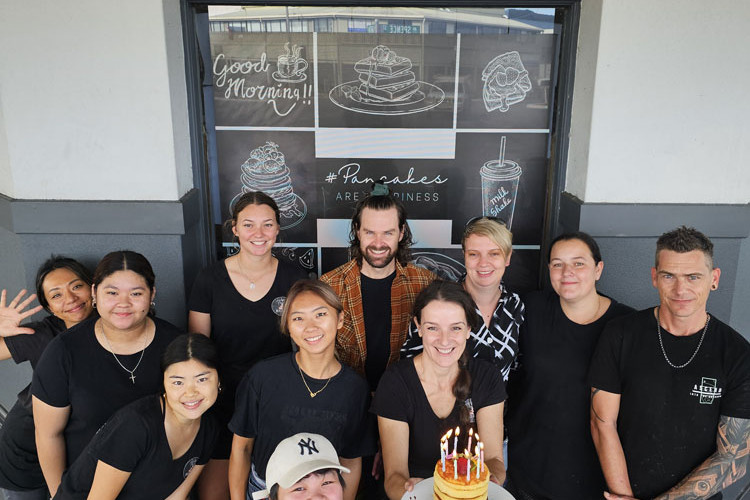 The Helga’s team (back row, from left) Seiko, Lily, Jacob, Sabrina, Tara, Grant, (middle row) Aaliyah, Uruha, Hestia, owner Birgit with the birthday pancake and at the front Kiki. Picture: Supplied