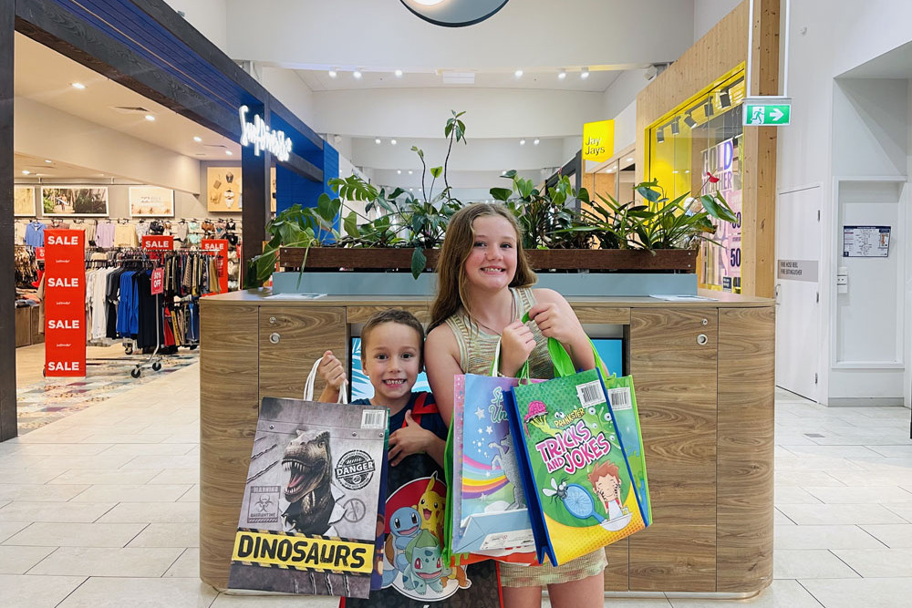Leo, five, (left) and Ocean Loudon, 11, with bags of goodies at Smithfield shopping centre. Picture: Supplied