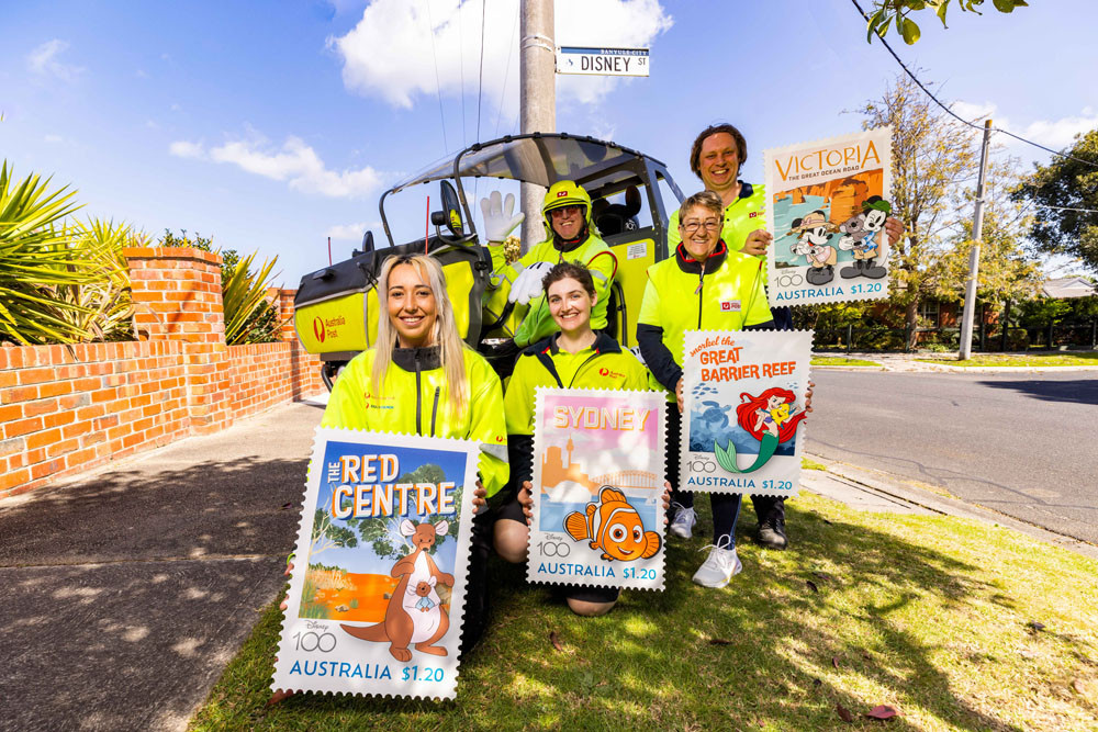 Posties Alex Holden, Julia Sinni, Andrew Kelly, Lynette Faye Vicary and Clinton Cope with posters of the new stamps. Picture: Australia Post