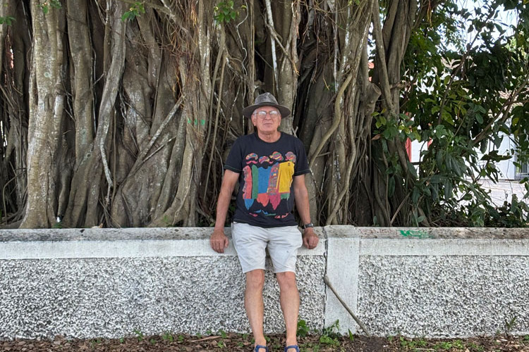 Environmentalist Paul Matthews in front of a fig tree outside St John’s Anglican Church in Minnie St, Cairns. The church wants the tree removed because of the damage it is causing. Picture: Andree Stephens