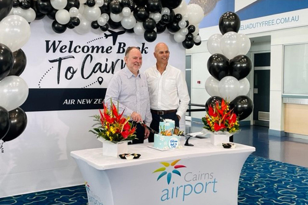 Dr Ken Chapman (left) and Richard Barker (right) welcome the arrivals at Cairns Airport