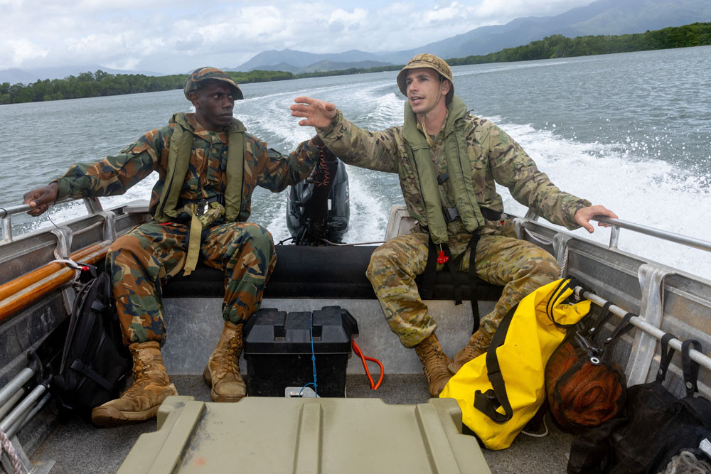 Vanuatu Mobile Force police officer Private Lokai Berthelemiu (left) practises his small-boat handling skills with Australian Army soldier Private Andrew Goebel in Trinity Inlet. Picture: Cpl Michael Currie