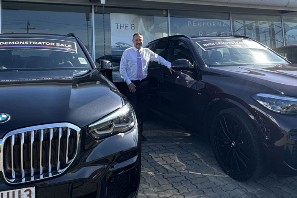 Westco BMW sales manager Grant Woolcock with two of the brand’s demonstrators on sale in Newell St, Cairns.