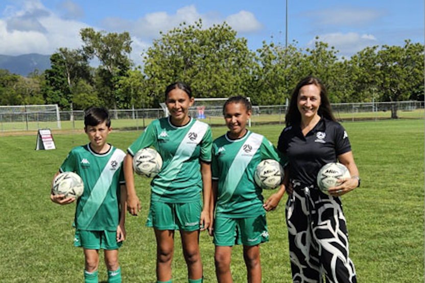 Football academy players (from left) Ren Cooper, 12, Ella Buie, 14, Nakaiyah Buie, 12, and Football Queensland regional manager Sarah Campbell at Endeavour Park. Picture: Nick Dalton