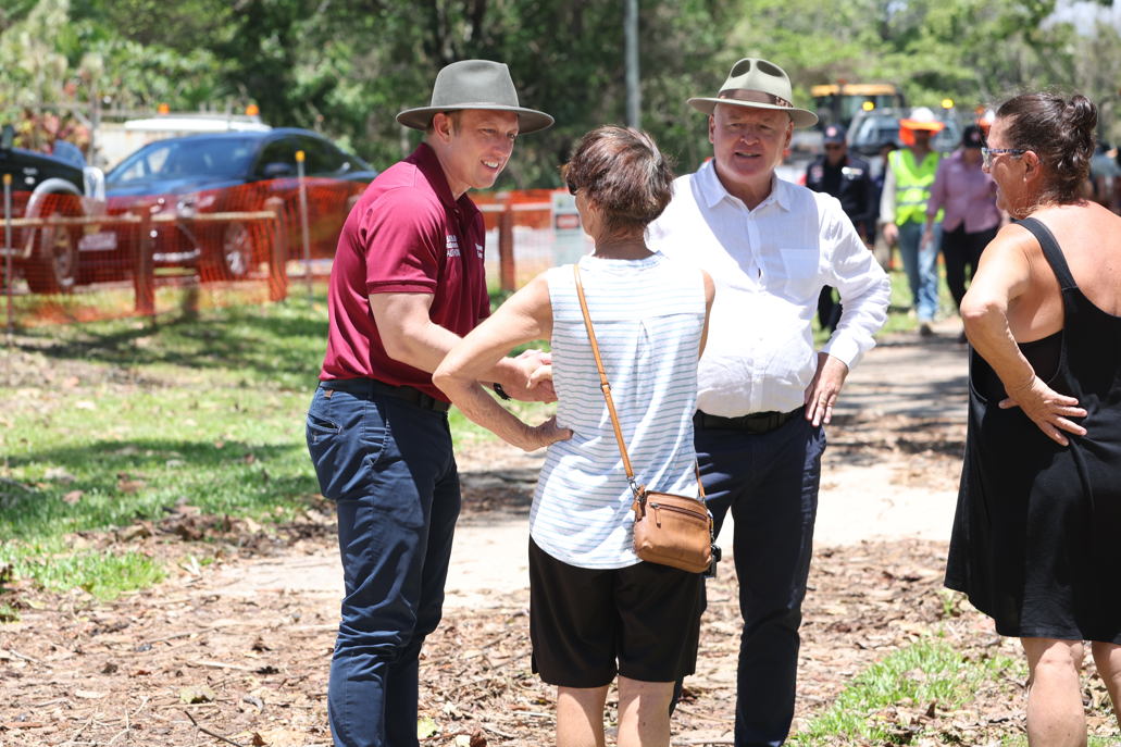 Premier Steven Miles (left) and Cairns MP and Tourism and Sports Minister Michael Healy chat to Holloways Beach residents about the impact of the floods. Picture: Annette Dew