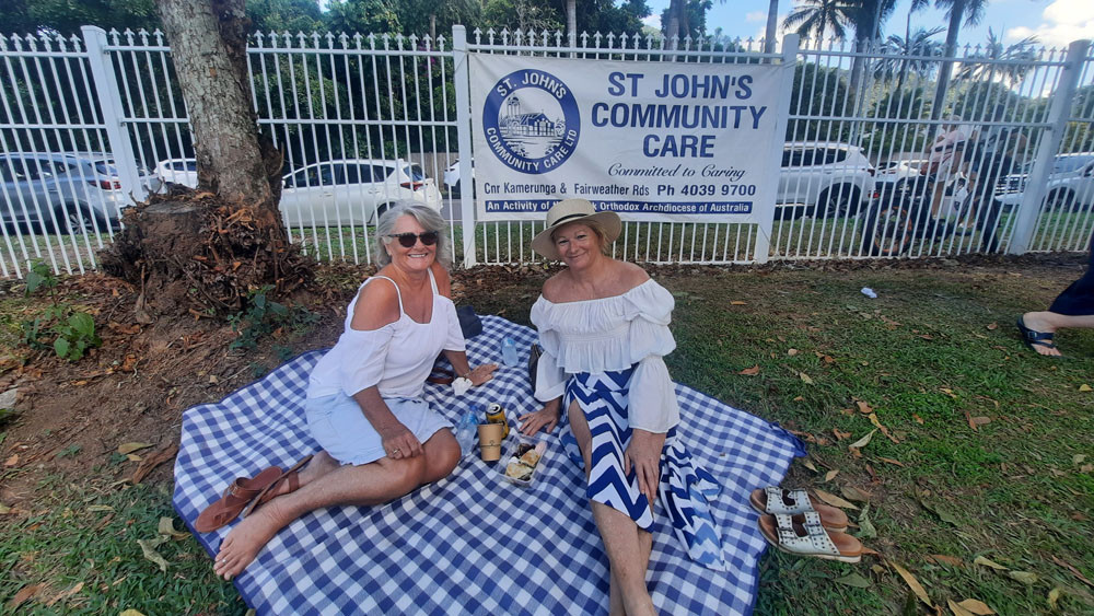 Colleen Robins (left) and Katie Spence enjoy a picnic in the church grounds.