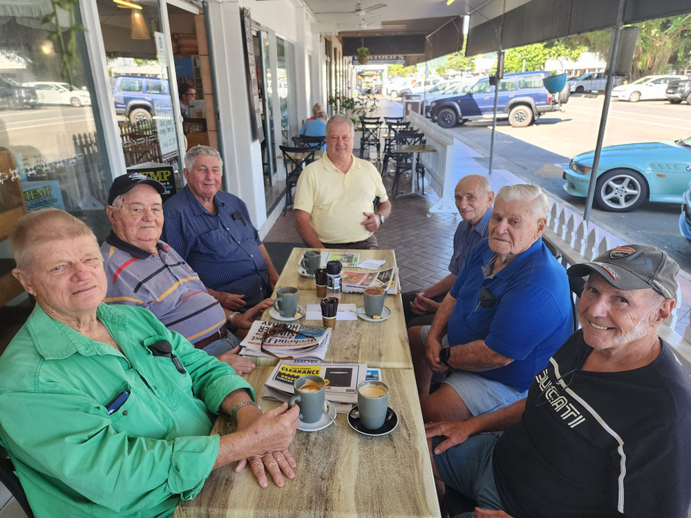 Local Mossman cane growers (from back anti-clockwise) Luciano Mason, Peter Verri, Santo D’addona. Russell Warland, Avro Solito, Gino Santarossa and Vittorio Bertoncini discuss the cane harvest issues over a coffee. Pictures: Suppled/ Gary ‘Gazza’ McIlroy