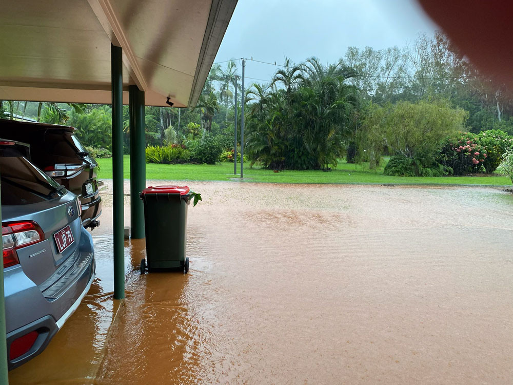 Top: The easement off Grey St came close to overflowing during recent heavy rain. Below: The Pavey driveway and carport were flooded for the first time in 37 years. Pictures: Supplied