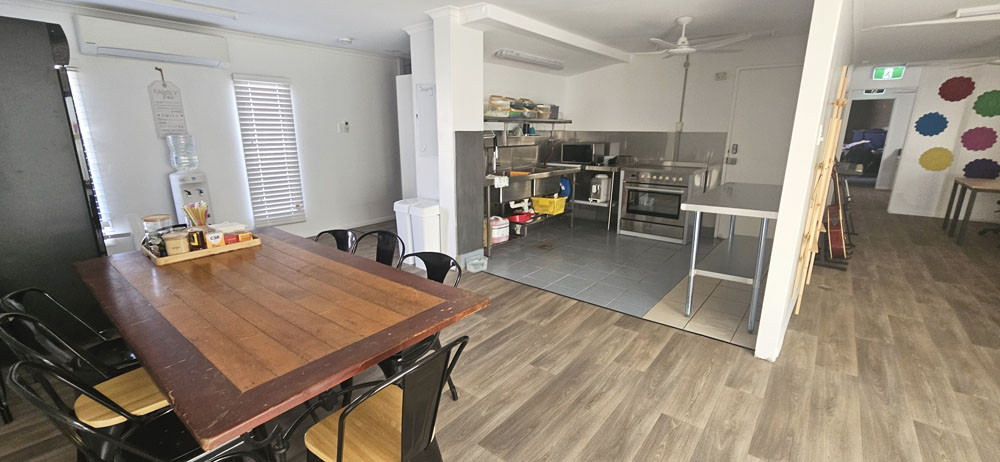 The hub includes a full kitchen, dining area and pantry.