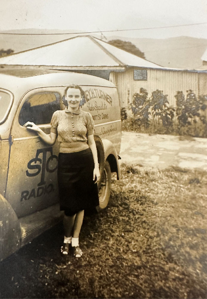 Evelyn Turner beside one of the delivery trucks brandishing the Sydney H. Turner name.
