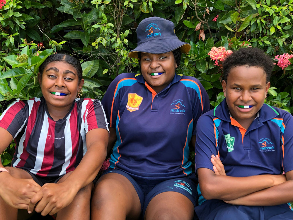 Cape York AFL House residents (from left) Marrell Lui and Jacklyn Kepa – both from Yam Island – and Badu’s Roby Toby will be flying the flag next time they run onto the football field