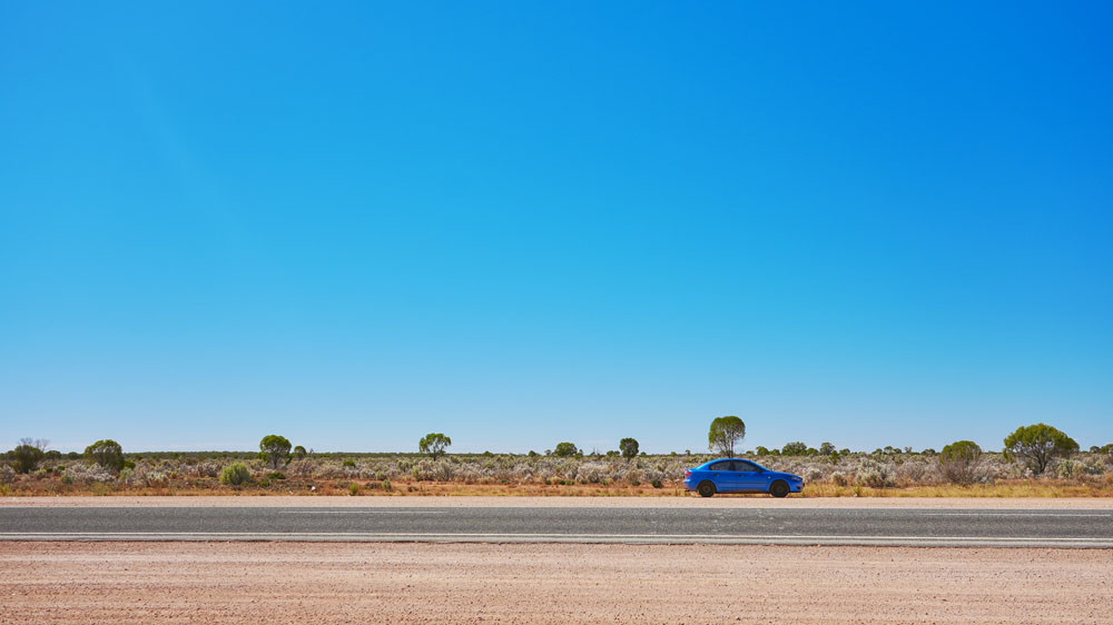 The ‘Blueberry’ Mazda3 in the middle of the Outback. Pictures: Supplied