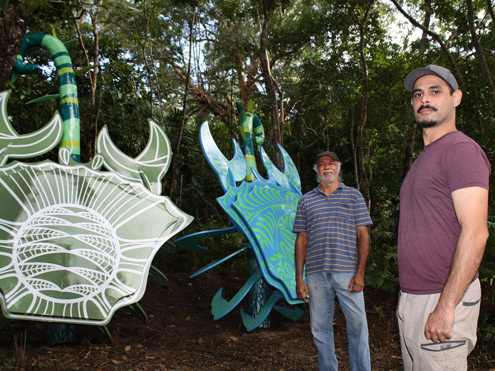 Yirrganydji artist Tarquin Singleton (right), who decorated the green crab, with Yidinji artist Hendrick Fourmile. (The Torres Strait Islander patterned blue and green crab was decorated by artist Brian Robinson)