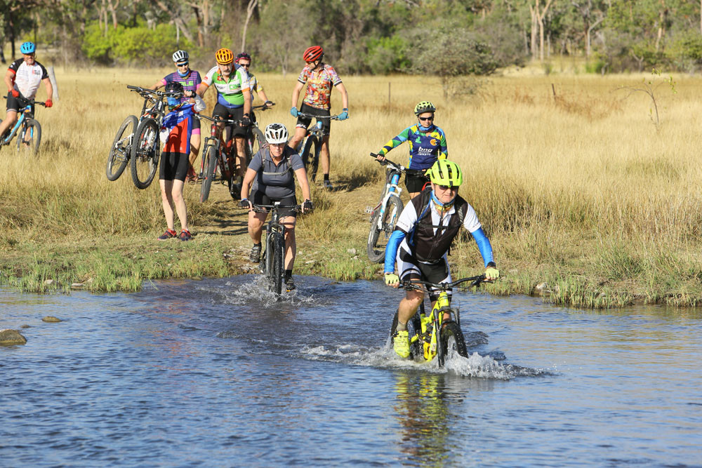 Cyclists tackle a water crossing