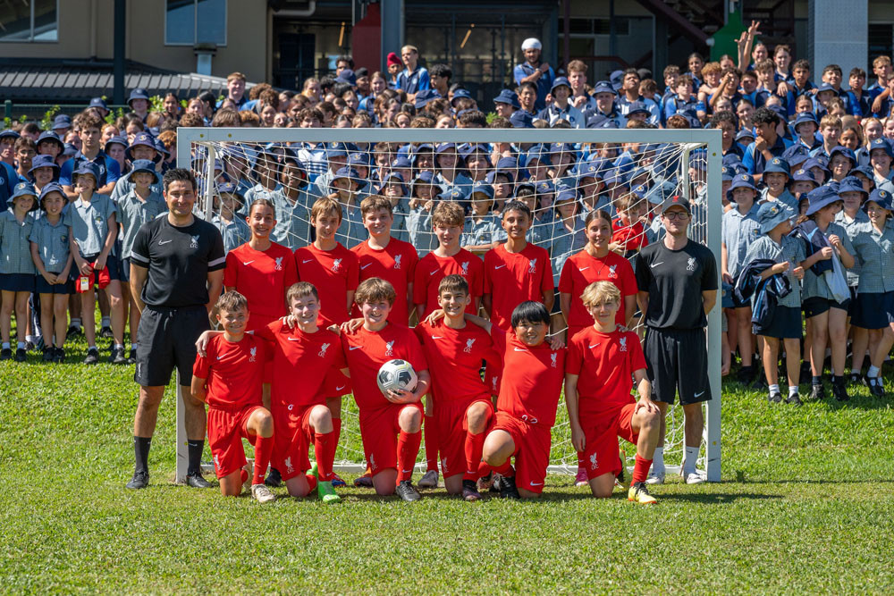 Liverpool FC head coach Kevin Grima, Good Counsel College PE teacher Jacob Vecchio and year 8 students who participated in the skills session.