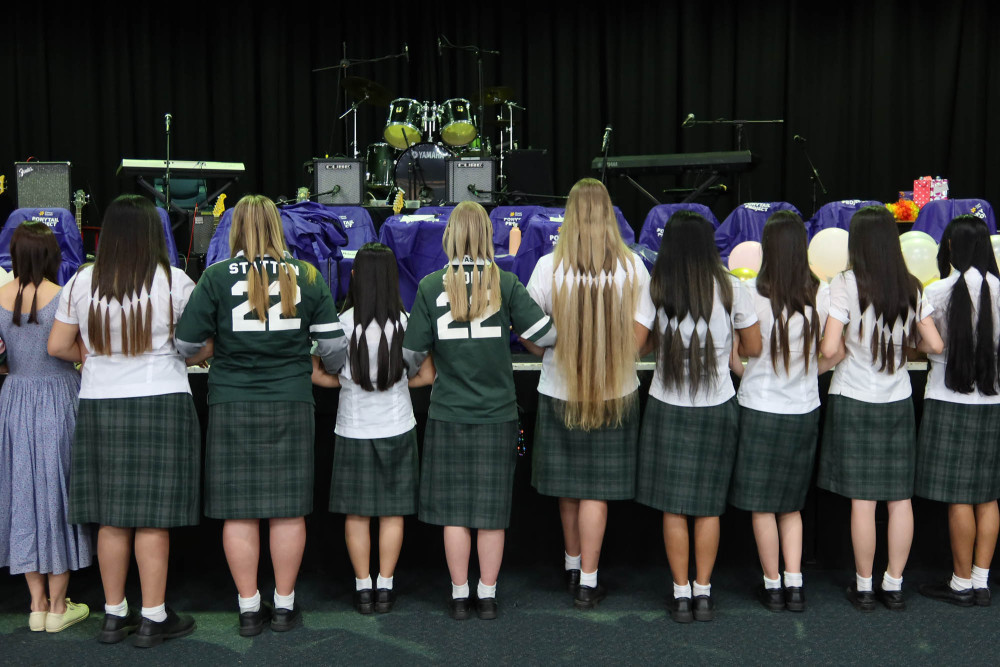 15 students and 3 teachers broke their own fundraising record by sacrificing their hair for a great cause