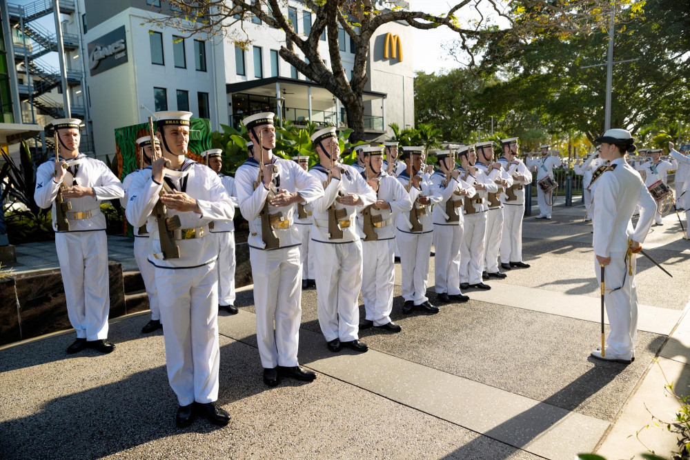 HMAS Cairns’ ceremonial guard salute during Freedom of Entry March through the city of Cairns. Image by ABIS Susan Mossop